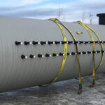 Side angle of an uninstalled geothermal vault placed on the surface of the ground.