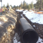 Weholite pipe placed in ditch in a construction site in the forest.