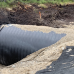 Weholite pipe being replaced in a construction digsite.