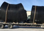Weholite pipe strapped down on a flatbed trailer for transportation.